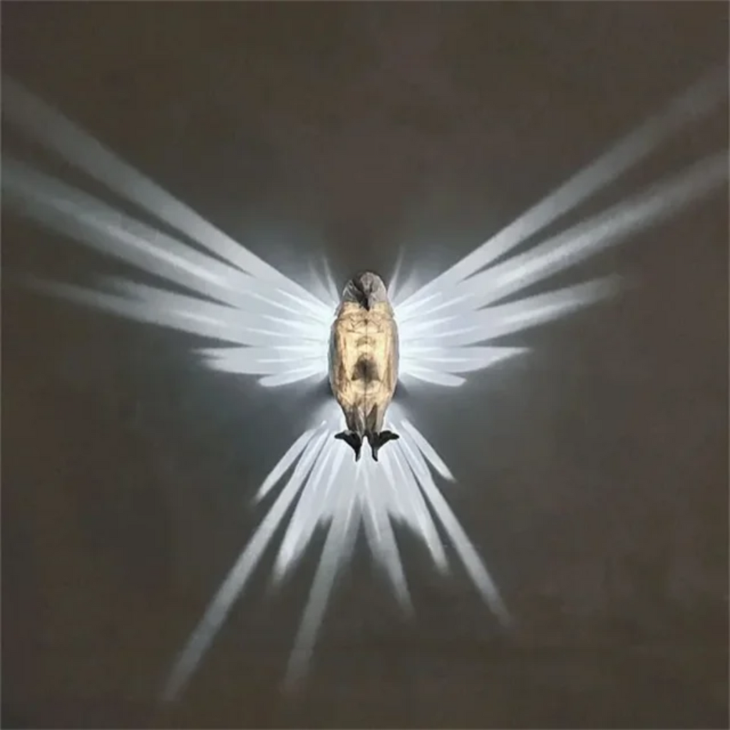 Illuminated Crystal Bird Lamp Casting Angel Wing Light Pattern